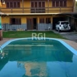 Elo8 Imóveis vende em Cachoeirinha, RS, Lote com Linda Casa residencial em rua tranquila!&lt;BR&gt;Com 03 (três) Dormitórios/quartos (sendo 01 suíte), 02 (dois) box/ vagas de garagem &lt;BR&gt;Descriç