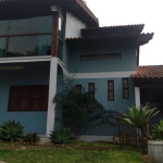 Casa no bairro Tarumã em Viamão.&lt;BR&gt;Imóvel com sala ampla, cozinha, sala de jantar, quatro banheiros, três dormitórios, uma suíte, lavanderia, duas vagas de garagem cobertas, portão eletrônico, 