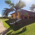 Sítio em Belém Novo, cercado - com casa de 3 dormitórios, sala living 2 ambientes, lareira, copa/cozinha, banheiro, lavanderia e garagem para 6 carros cobertos. Espaço com árvores frutíferas e estufa.