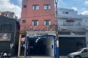 Prédio residencial de 2 andares com 4 apartamentos e um comércio no térreo.