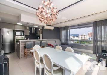 Apartamento semi mobiliado com três dormitórios sendo um suíte, churrasqueira, cozinha americana integrada com living dois ambientes, lavabo, andar alto com vista definida. são duas vagas de garagem c