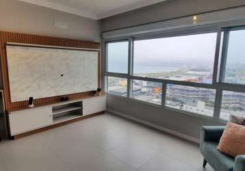 Studio mobiliado com 1 vaga e vista mar para locação em campinas.