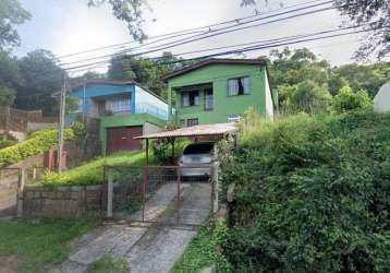 Terreno com duas casas estilo sobrado. a casa principal possui na parte superior 2 dormitórios, living 2 ambientes, banheiro social, cozinha. na parte inferior: living amplo estilo salão de festas com