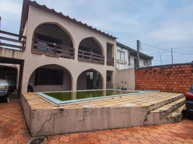 Casa com terreno de 220m², com 03 dormitórios, 02 banheiros, living 2 ambientes com lareira, cozinha, área de serviço, espaço com churrasqueira, sacada, pátio, piscina e garagem para 04 carros.&lt;BR&