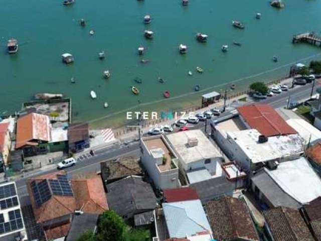 Terreno com escritura pública com casa de 2 dormitórios com vista para o mar