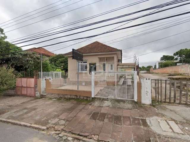 Terreno no bairro Teresópolis, com 520m² (10 x 52m) contendo 3 residências. Casa da frente de madeira possui sala de estar, cozinha, 4 dormitórios, 2 banheiros e pátio em frente com garagem descoberta