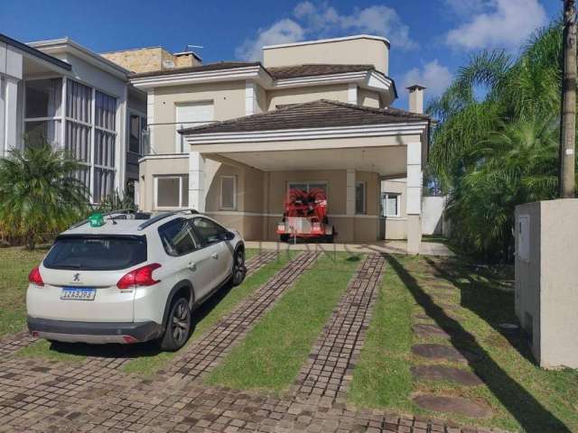 Casa com 3 dormitórios para alugar, 220 m² por R$ 10.138,52 - Alphaville - Gravataí/RS