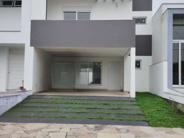 Linda Casa com três dormitórios sendo uma suíte com sacada e closet, cozinha ampla, living dois ambientes e com lareira, pé direito duplo, duas vagas de garagem coberta, condomínio com infra completa,