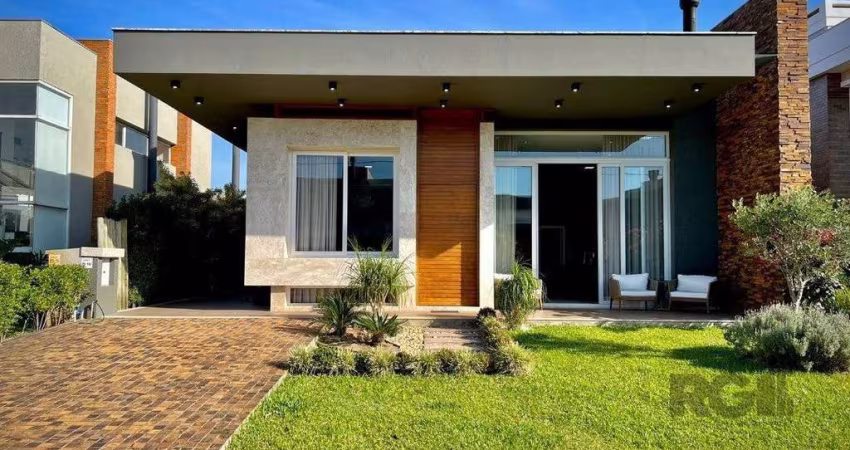 Casa térrea no Condomínio Village Atlântida com 250 m2 de área privativa, 4 suítes, totalmente decorada e equipada, com living estendido amplo de 60m², pé direto de 4.5m de altura e lareira ecológica.